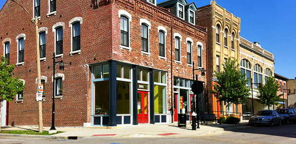 An exterior of three historic brick buildings at Crown Square, with retail space.